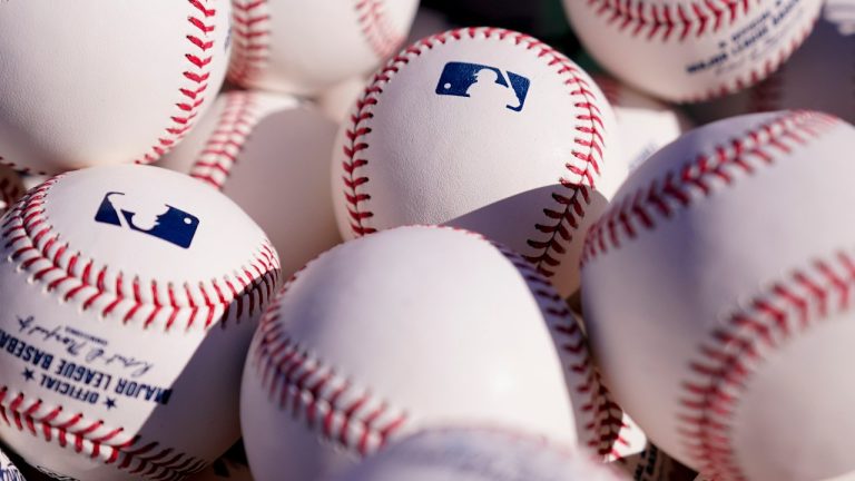 MLB baseballs fill a bag on the field. (Matt Slocum/AP)