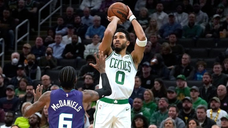 Boston Celtics forward Jayson Tatum (0)pulls up for a jumper against Charlotte Hornets forward Jalen McDaniels (6) during the first half of an NBA basketball game, Monday, Nov. 28, 2022, in Boston. (Steven Senne/AP Photo)