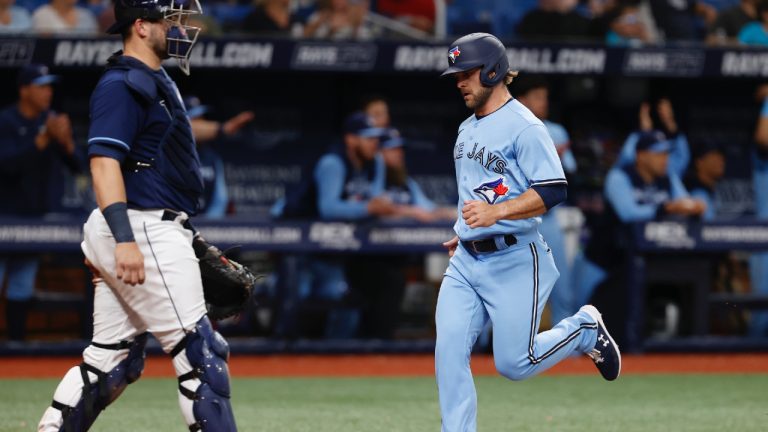 Toronto Blue Jays' Vinny Capra, right, runs by Tampa Bay Rays catcher Mike Zunino to score during the eighth inning of a baseball game Friday, May 13, 2022, in St. Petersburg, Fla. (Scott Audette/AP)