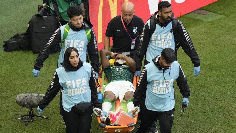 Paramedics carry Saudi Arabia's Yasser Al-Shahrani on a stretcher during the World Cup group C soccer match between Argentina and Saudi Arabia at the Lusail Stadium in Lusail, Qatar, Tuesday, Nov. 22, 2022. (Luca Bruno/AP)