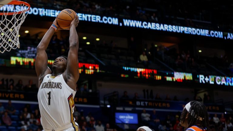 New Orleans Pelicans forward Zion Williamson (1) dunks past Oklahoma City Thunder guard Shai Gilgeous-Alexander, center, in the third quarter of an NBA basketball game in New Orleans, Monday, Nov. 28, 2022. (Derick Hingle/AP Photo)