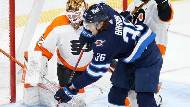 Winnipeg Jets' Morgan Barron (36) tips the puck towards Philadelphia Flyers goaltender Felix Sandstrom (32) during third period NHL action in Winnipeg, Wednesday, April 27, 2022. (John Woods/CP)