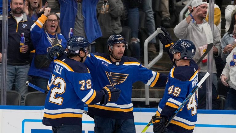 St. Louis Blues' Jordan Kyrou is congratulated by Justin Faulk (72) and Ivan Barbashev (49) after scoring during the second period of an NHL hockey game against the San Jose Sharks Thursday, Nov. 10, 2022, in St. Louis. (Jeff Roberson/AP Photo)