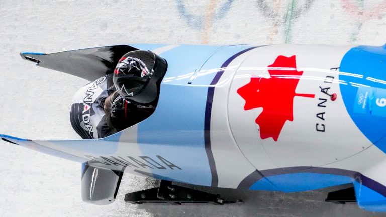 Christine De Bruin and Kristen Bujnowski, of Canada, slide during the women's bobsleigh heat 3 at the 2022 Winter Olympics, Saturday, Feb. 19, 2022, in the Yanqing district of Beijing. (AP Photo/Mark Schiefelbein)