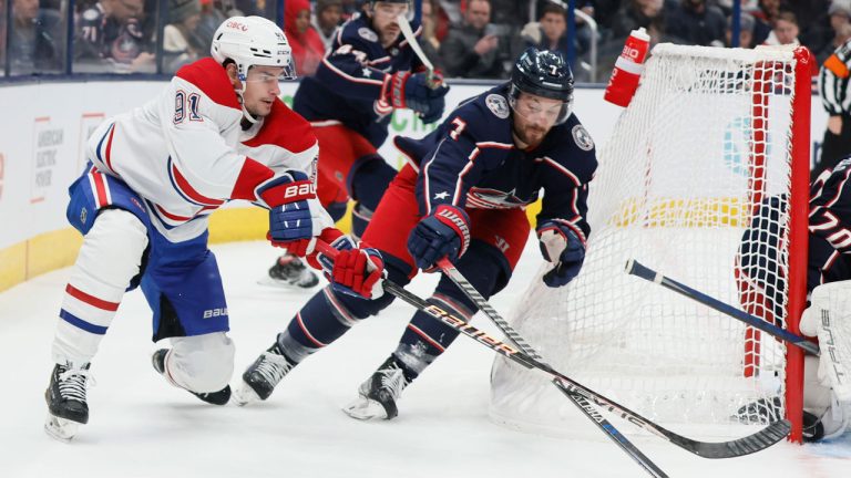 Montreal Canadiens' Sean Monahan, left, and Columbus Blue Jackets' Sean Kuraly (7) chase the puck during the third period of an NHL hockey game. (Jay LaPrete/AP)