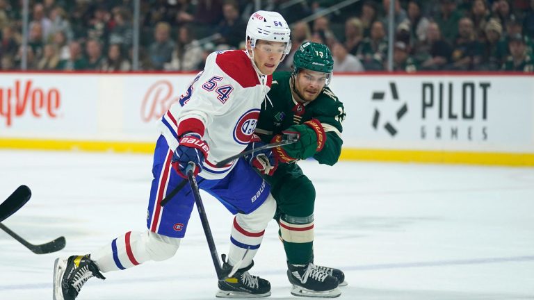 Montreal Canadiens defenseman Jordan Harris (54) and Minnesota Wild center Sam Steel (13) battle for the puck during the first period of an NHL hockey game. (Abbie Parr/AP)