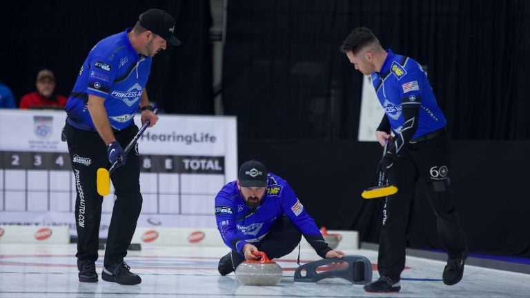 Reid Carruthers (centre) delivers a rock as Derek Samagalski (left) and Connor Njegovan (right) prepare to sweep during the 2022 HearingLife Tour Challenge at the Coca-Cola Centre in Grande Prairie, Alta. (Anil Mungal/GSOC)