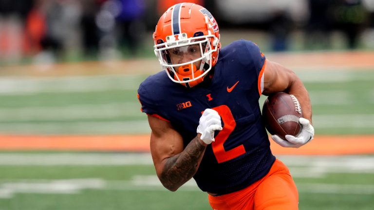 Illinois running back Chase Brown carries the ball during the first half of an NCAA college football game against Purdue Saturday, Nov. 12, 2022, in Champaign, Ill. (Charles Rex Arbogast/AP)