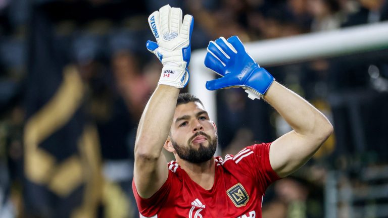 Los Angeles FC goalkeeper Maxime Crepeau gestures to fans as he warms up for an MLS playoff soccer match against the LA Galaxy. (Ringo H.W. Chiu/AP)