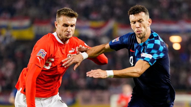 Austria's Stefan Posch, left, duels for the ball with Croatia's Ivan Perisic during the UEFA Nations League soccer match between Austria and Croatia at the Ernst Happel Stadion in Vienna, Austria, Sunday, Sept. 25, 2022. (AP Photo/Florian Schroetter)