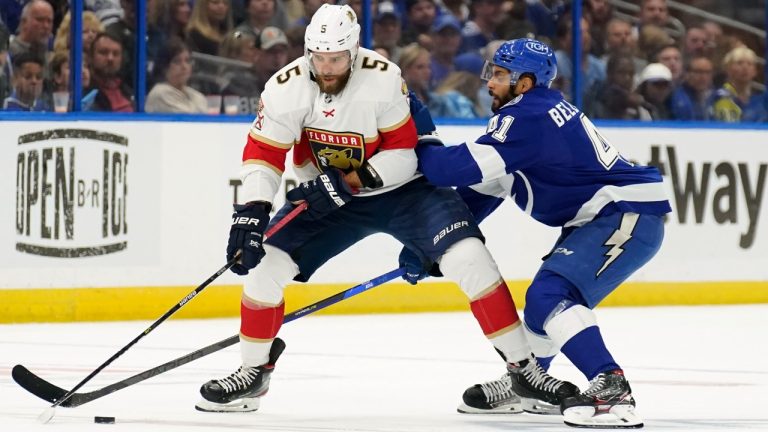 Florida Panthers defenseman Aaron Ekblad (5) gets hit by Tampa Bay Lightning left wing Pierre-Edouard Bellemare (41) as he carries the puck during the first period in Game 4 of an NHL hockey second-round playoff series Monday, May 23, 2022, in Tampa, Fla. (Chris O'Meara/AP)