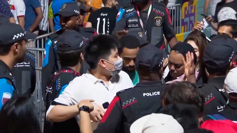 In this image from video, Qatari police try to control a crowd at a FIFA Fan Zone ahead of the World Cup in Doha, Qatar, Saturday, Nov. 19, 2022. Authorities turned away thousands of fans Saturday night from a concert celebrating the World Cup beginning the next day in Qatar, revealing the challenges ahead for Doha as it tries to manage crowds in FIFA's most-compact tournament ever. (AP Photo/Srdjan Nedeljkovic) 