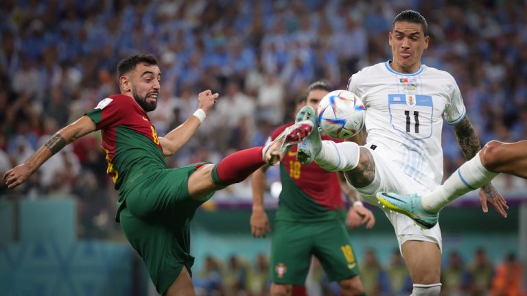 Portuguese Bruno Fernandes and Uruguay's Darwin Nunez fight for the ball during a soccer game between Portugal and Uruguay, in Group H of the FIFA 2022 World Cup in Lusail Stadium, in Lusail, State of Qatar on Monday 28 November 2022. (AP)