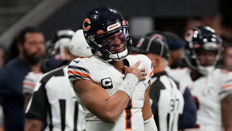 Chicago Bears quarterback Justin Fields (1) holds his shoulder after a Atlanta Falcons tackle during the second half of an NFL football game. (John Bazemore/AP)