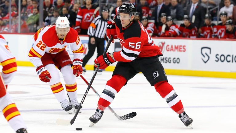 New Jersey Devils left wing Erik Haula (56) skates with the puck against Calgary Flames center Trevor Lewis (22) during the first period of an NHL hockey game, Tuesday, Nov. 8, 2022, in Newark, N.J. (Noah K. Murray/AP)