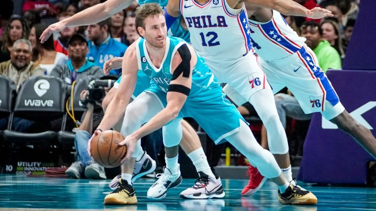 Charlotte Hornets forward Gordon Hayward, front, gets pressured by Philadelphia 76ers forward Tobias Harris (12) during the second half of an NBA basketball game Wednesday, Nov. 23, 2022, in Charlotte, N.C. (Rusty Jones/AP)