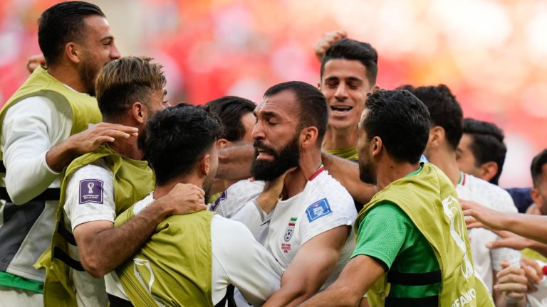 Iran's Rouzbeh Cheshmi, center, celebrates scoring the opening goal with teammates during the World Cup group B soccer match between Wales and Iran, at the Ahmad Bin Ali Stadium in Al Rayyan , Qatar, Friday, Nov. 25, 2022. (Francisco Seco/AP)