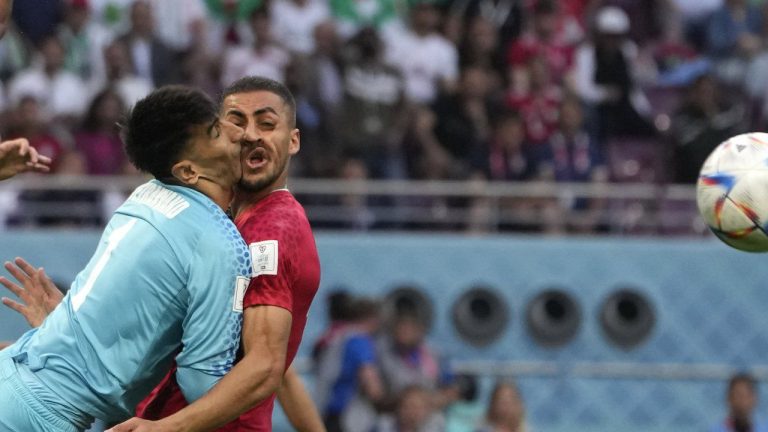 Iran's goalkeeper Alireza Beiranvand collides with Iran's Majid Hosseini, right, during the World Cup group B soccer match between England and Iran at the Khalifa International Stadium in Doha, Qatar, Monday, Nov. 21, 2022. (Alessandra Tarantino/AP)