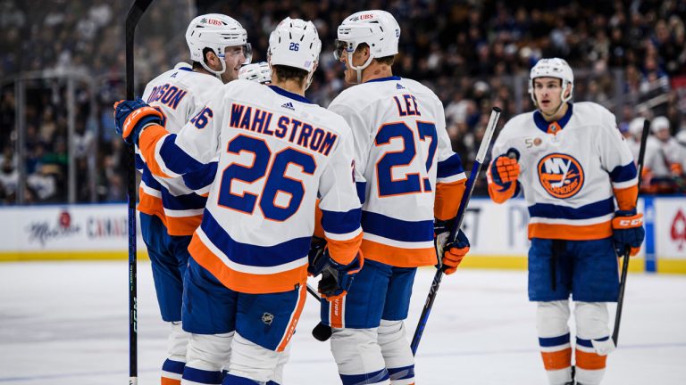 New York Islanders defenceman Noah Dobson (8) celebrates with teammates after scoring during first period NHL hockey action against the Toronto Maple Leafs. (Christopher Katsarov/CP)