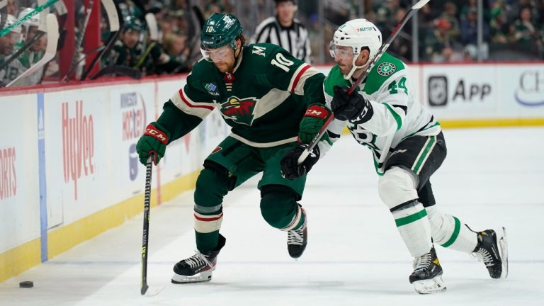 Minnesota Wild center Tyson Jost (10) and Dallas Stars defenseman Joel Hanley (44) vie for the puck during the third period of an NHL preseason hockey game Saturday, Oct. 8, 2022, in St. Paul, Minn. (Abbie Parr/AP)