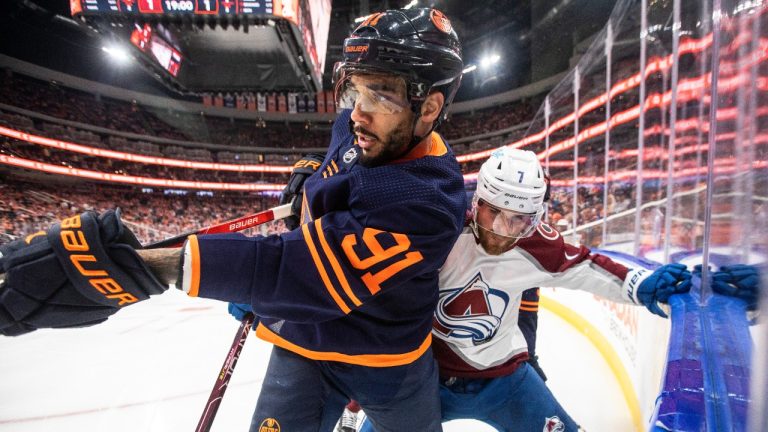 Colorado Avalanche' Devon Toews (7) and Edmonton Oilers' Evander Kane (91) battle on the corner during second period NHL conference finals action in Edmonton on Saturday, June 4, 2022. (Jason Franson/CP)