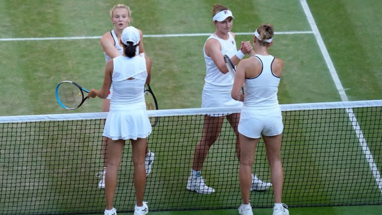 FILE - Barbora Krejcikova, top right, and Katerina Siniakova of the Czech Republic, celebrate after beating China's Shuai Zhang, bottom left, and Belgium's Elise Mertens during the final of the women's doubles at the Wimbledon tennis championships in London, on July 10, 2022. Wimbledon is relaxing its requirement for all-white clothing to allow female players to wear colored undershorts to be more comfortable on their periods. (Kirsty Wigglesworth/AP)