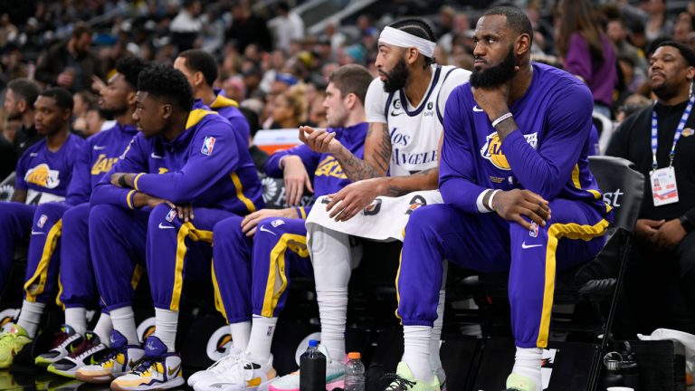 Los Angeles Lakers' LeBron James, right, watches from the bench during the second half of the team's NBA basketball game against the San Antonio Spurs. (Darren Abate/AP)