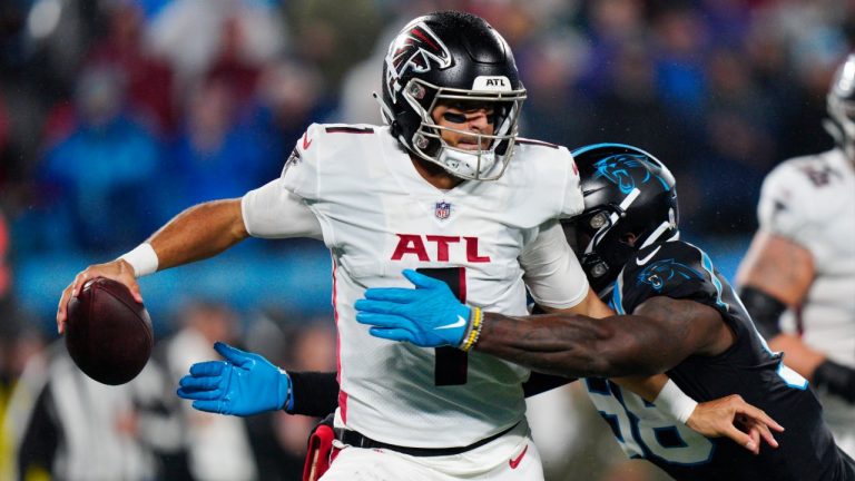 Atlanta Falcons quarterback Marcus Mariota is sacked by Carolina Panthers defensive end Marquis Haynes Sr. during the second half of an NFL football game on Thursday, Nov. 10, 2022, in Charlotte, N.C. (Jacob Kupferman/AP)