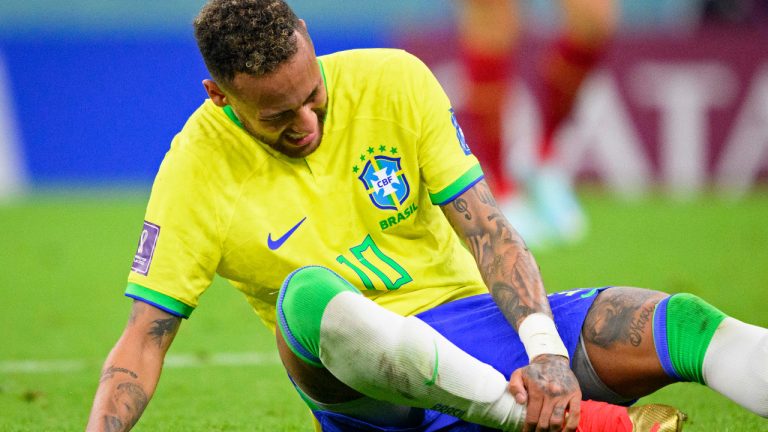 Brazil's Neymar grabs his ankle after an injury during the World Cup group G soccer match between Brazil and Serbia, at the the Lusail Stadium in Lusail, Qatar on Thursday, Nov. 24, 2022. (Laurent Gillieron/Keystone via AP) 