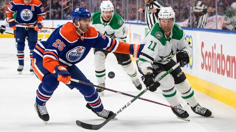 Dallas Stars' Luke Glendening (11) and Edmonton Oilers' Darnell Nurse battle for the puck during first period NHL action in Edmonton, Saturday, Nov. 5, 2022. (Jason Franson/THE CANADIAN PRESS)