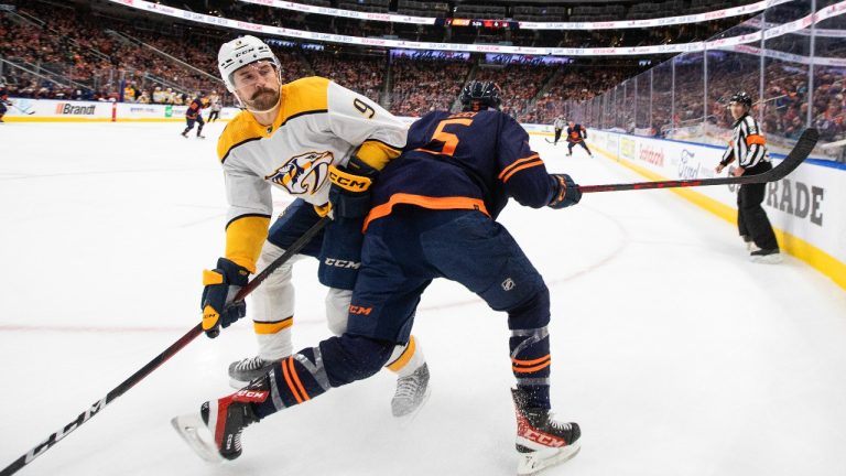 Nashville Predators' Filip Forsberg (9) checks Edmonton Oilers' Cody Ceci (5) during first period NHL action in Edmonton, Tuesday, Nov. 1, 2022. (Jason Franson/THE CANADIAN PRESS)