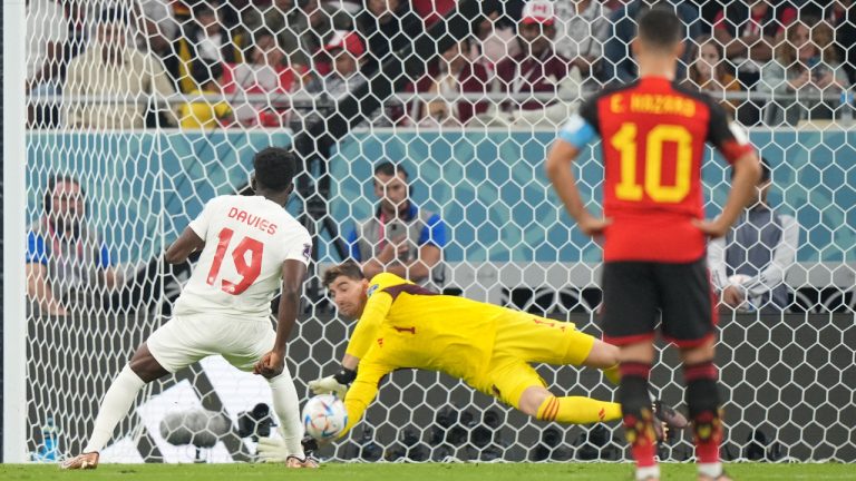 Belgium goalkeeper Thibaut Courtois (1) makes a save on a penalty kick from Canada forward Alphonso Davies (19) during first half Group F World Cup soccer action at Ahmad bin Ali Stadium in Al Rayyan, Qatar, on Wednesday, Nov. 23, 2022. (Nathan Denette/CP)