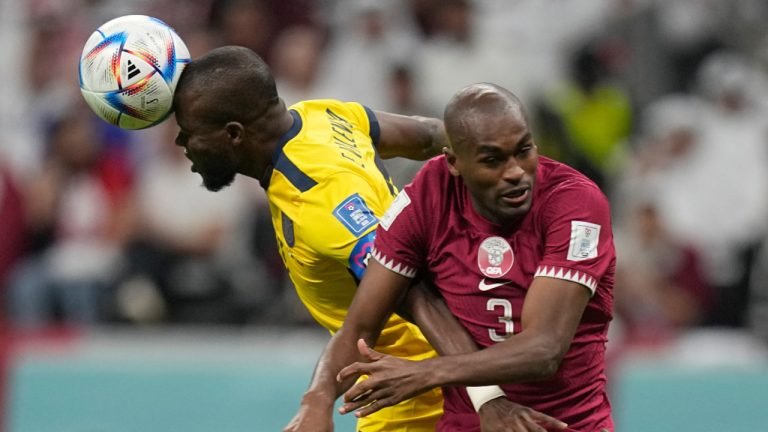 Ecuador's Enner Valencia, left, duels for the ball with Qatar's Abdelkarim Hassan during the World Cup, group A soccer match between Qatar and Ecuador at the Al Bayt Stadium in Al Khor, Sunday, Nov. 20, 2022. (AP Photo/Ariel Schalit) 