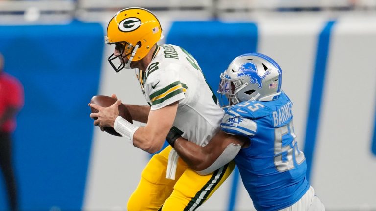 Green Bay Packers quarterback Aaron Rodgers (12) is sacked by Detroit Lions linebacker Derrick Barnes (55) during the first half of an NFL football game, Sunday, Nov. 6, 2022, in Detroit. (AP Photo/Paul Sancya)