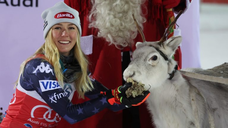 United States' Mikaela Shiffrin feeds a young reindeer after winning an alpine ski, women's World Cup slalom, in Levi, Finland, Saturday, Nov. 19, 2022. (Alessandro Trovati/AP)