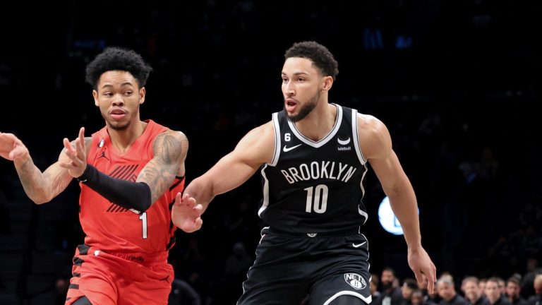 Portland Trail Blazers guard Anfernee Simons (1) passes the ball away from Brooklyn Nets guard Ben Simmons (10) during the first half of an NBA basketball game Sunday, Nov. 27, 2022, in New York. (AP Photo/Jessie Alcheh)