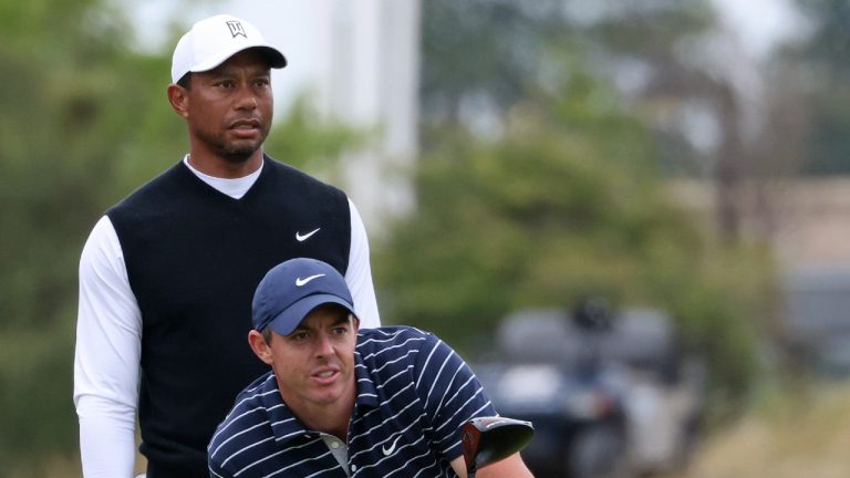 Northern Ireland's Rory McIlroy and Tiger Woods of the US prepare to tee-off during a 'Champions round' as preparations continue for the British Open golf championship on the Old Course at St. Andrews, Scotland, Monday July 11, 2022. The Open Championship returns to the home of golf on July 14-17, 2022, to celebrate the 150th edition of the sport's oldest championship, which dates to 1860 and was first played at St. Andrews in 1873. (AP Photo/Peter Morrison)