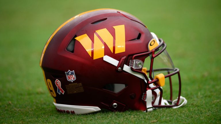 A helmet for the Washington Commanders player sits on the field before the start of the first half of an NFL football game against the Jacksonville Jaguars, Sunday, Sept. 11, 2022, in Landover, Md. (Nick Wass/AP)