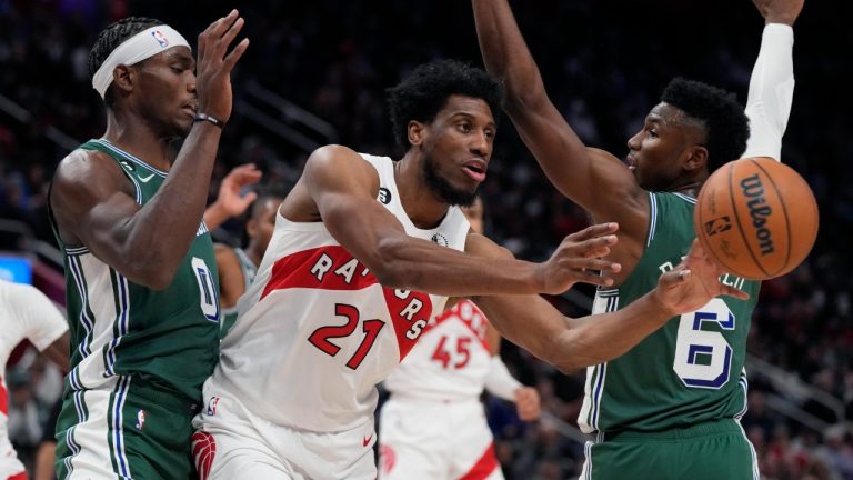 Toronto Raptors forward Thaddeus Young (21) passes the ball as Detroit Pistons center Jalen Duren (0) defends during the second half of an NBA basketball game, Monday, Nov. 14, 2022, in Detroit. (Carlos Osorio/AP)