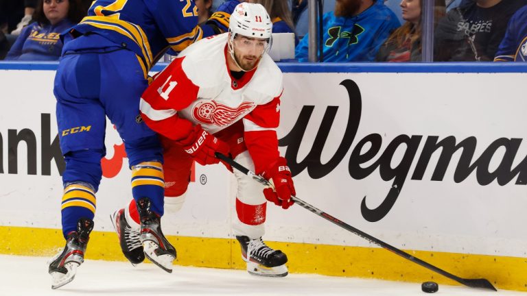 Detroit Red Wings right wing Filip Zadina (11) is checked by Buffalo Sabres right wing Jack Quinn (22) during the first period of an NHL hockey game, Monday, Oct. 31, 2022, in Buffalo, N.Y. (Jeffrey T. Barnes/AP)