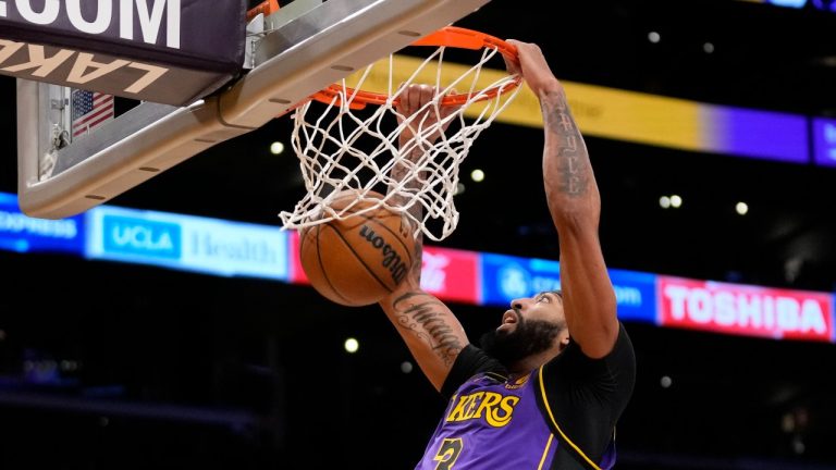 Los Angeles Lakers forward Anthony Davis (3) dunks during the first half of an NBA basketball game against the Denver Nuggets in Los Angeles, Friday, Dec. 16, 2022. (Ashley Landis/AP Photo)