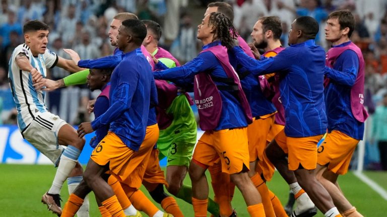 Netherlands alternate players confront Argentina's Nahuel Molina, left,during the World Cup quarterfinal soccer match between the Netherlands and Argentina, at the Lusail Stadium in Lusail, Qatar, Friday, Dec. 9, 2022. (Ricardo Mazalan/AP Photo)