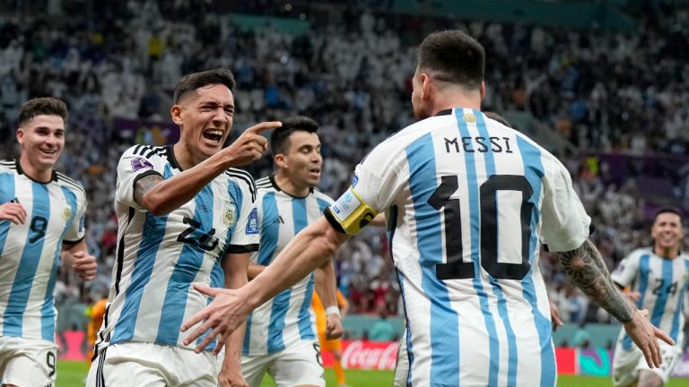 Argentina's Nahuel Molina, center, celebrates with Lionel Messi, right, after scoring the opening goal during the World Cup quarterfinal soccer match between the Netherlands and Argentina. (Ricardo Mazalan/AP)