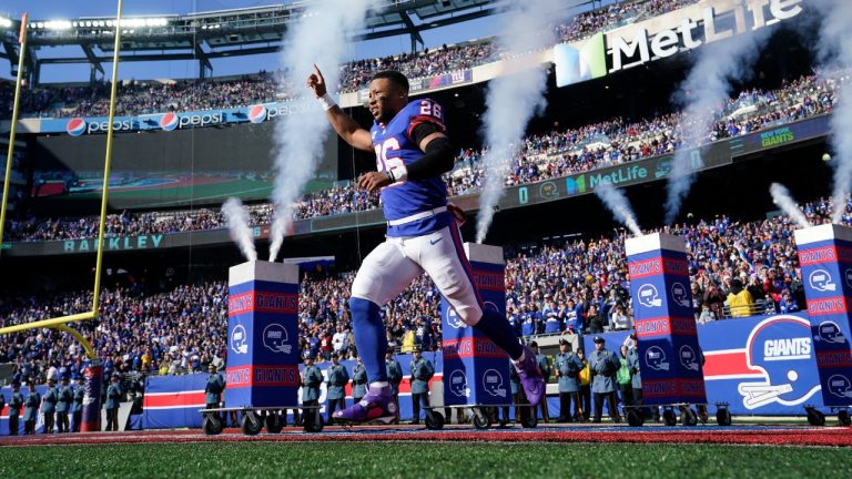 New York Giants' Saquon Barkley runs on the field before an NFL football game against the Washington Commanders, Sunday, Dec. 4, 2022, in East Rutherford, N.J. (John Minchillo/AP Photo)