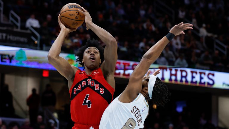 Toronto Raptors forward Scottie Barnes (4) shoots against Cleveland Cavaliers forward Lamar Stevens (8) during the second half of an NBA basketball game Friday, Dec. 23, 2022, in Cleveland. (Ron Schwane/AP)