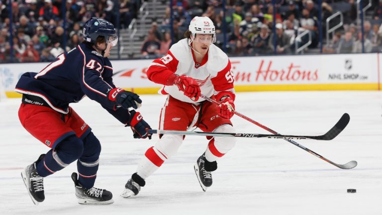 Detroit Red Wings' Tyler Bertuzzi, right, carries the puck across the blue line as Columbus Blue Jackets' Marcus Bjork defends during the third period of an NHL hockey game on Saturday, Nov. 19, 2022, in Columbus, Ohio. (Jay LaPrete/AP)