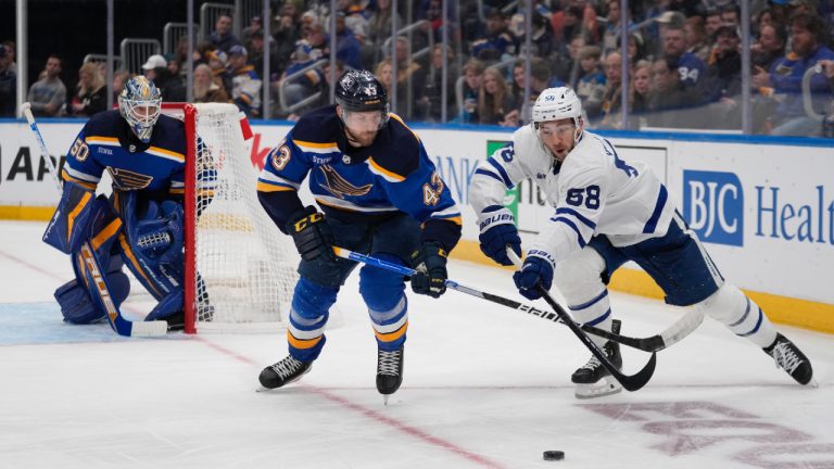 Toronto Maple Leafs' Michael Bunting (58) and St. Louis Blues' Calle Rosen (43) chase after a loose puck as Blues goaltender Jordan Binnington (50) watches during the first period of an NHL hockey game Tuesday, Dec. 27, 2022, in St. Louis. (Jeff Roberson/AP)