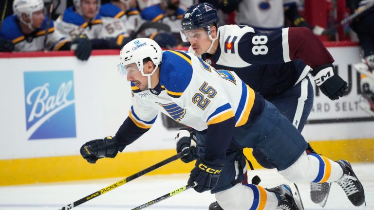 St. Louis Blues center Jordan Kyrou (25) tumbles while racing to recover the puck with Colorado Avalanche defenseman Andreas Englund (88) in the second period of an NHL hockey game Monday, Nov. 14, 2022, in Denver. (David Zalubowski/AP)