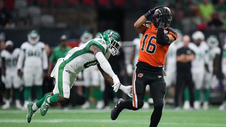 B.C. Lions' Bryan Burnham, right, makes the reception as Saskatchewan Roughriders' Rolan Milligan defends during the first half of CFL football game action in Vancouver on Friday, August 26, 2022. (Darryl Dyck/CP)