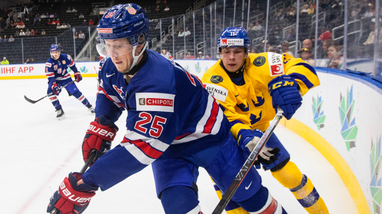 USA's Tyler Kleven (25) and Sweden's Fabian Lysell (11) battle for the puck during first period IIHF World Junior Hockey Championship action in Edmonton on Sunday August 14, 2022. (CP)